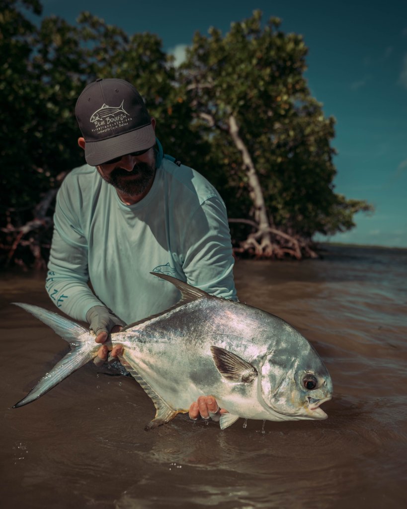 holding a permit after a long day of permit fishing in belize