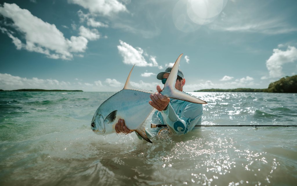 an angler and a permit after a long fight